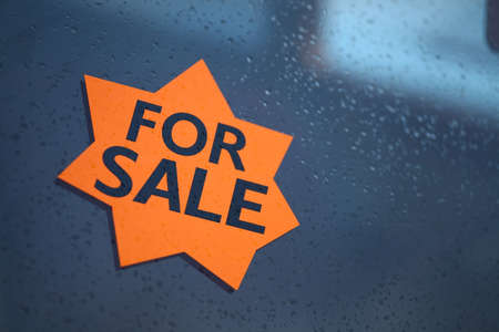 A "For Sale" sign displayed on a window.の写真素材