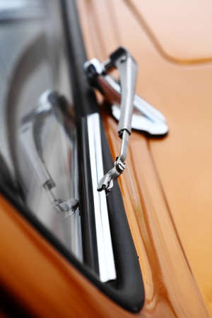 Color vertical shot of a vintage car screen wiper.