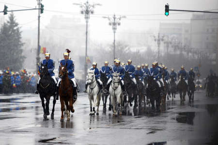Bucharest, Romania - December 1, 2014: Mounted soldiers ride horses during celebrations for...