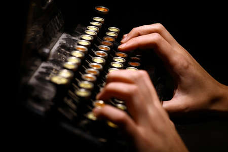 Color horizontal detail of the keyboard of an old typewriter and two hands.の写真素材