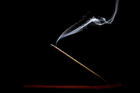 Studio shot of a burning incense on a black .の写真素材