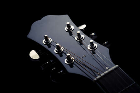 Head stock of a dark solo guitar.の写真素材