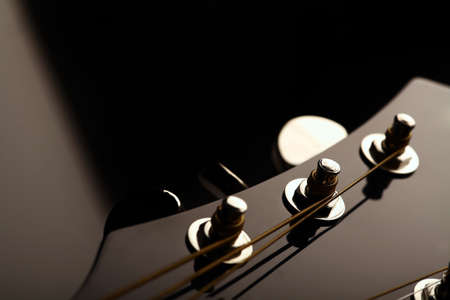 Head stock of a dark solo guitar.の写真素材