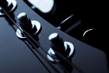 Head stock of a dark solo guitar.の写真素材