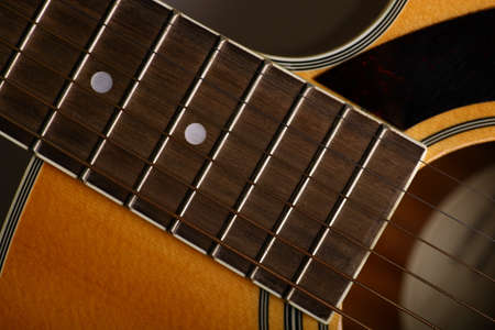 Color detail of an old, acoustic guitar.