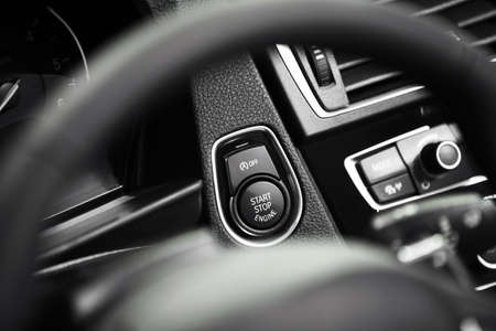 Detail on a black start button in a car.