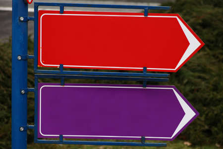 Picture of two colored and empty directional signs.