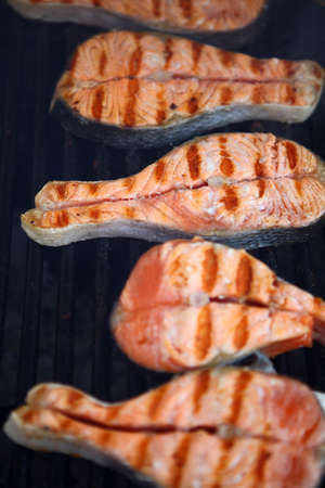 Color detail shot of some salmon fillet on a grill.の写真素材