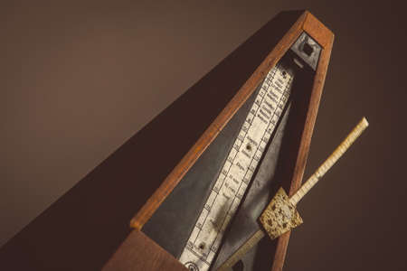 Color shot of a vintage metronome, on a black background.の写真素材