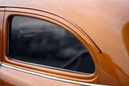 Color picture of a vintage car's back side window.の写真素材