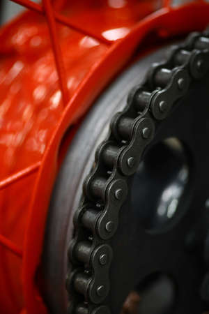 Close up shot of the chain of a motorcycle.