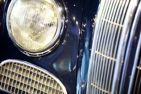 Color image with the headlight of a vintage car.