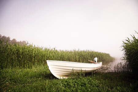 Color image of a white boat on a foggy day.の写真素材