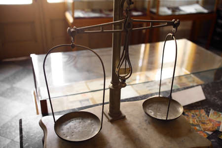 Color image of a vintage balance in a room.