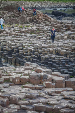 Co.Antrim, Northern Ireland - July 30, 2015: A group of tourists exploring the Giant's Causeway in the Summer of 2015.のeditorial素材