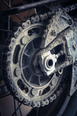 Close up image of a muddy motorcycle chain.