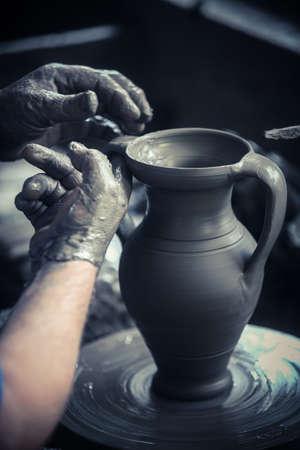 Color image with the hands of a potter working.の写真素材
