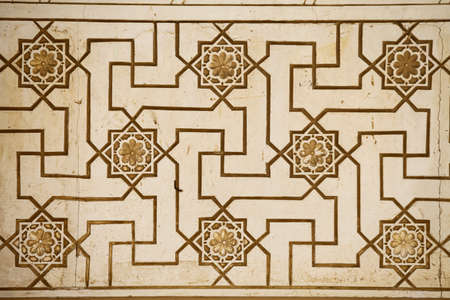 Close up shot of some Arabic decorations on a wall.