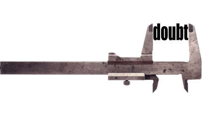 Color horizontal shot of a caliper measuring the word "doubt".の写真素材
