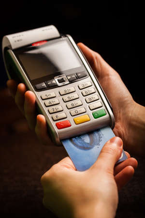 Color image of a POS and credit cards.