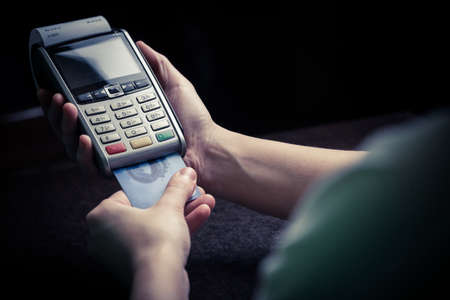 Color image of a POS and credit cards.