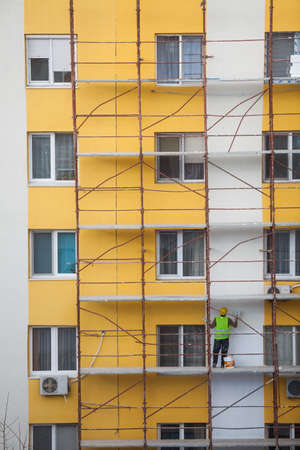 Bucharest, Romania - February 12, 2016: Color image of some construction workers on a scaffold in Bucharest, Romania.のeditorial素材