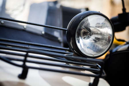 Color image of a classic motorcycle headlight.