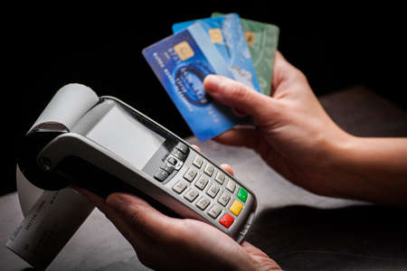 Color image of a POS and credit cards.