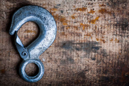 Color image of an metal hook on a wooden plank.の写真素材