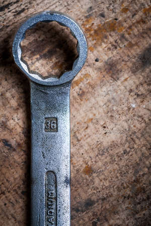 Color image of a ring wrench on a wooden plank.の写真素材