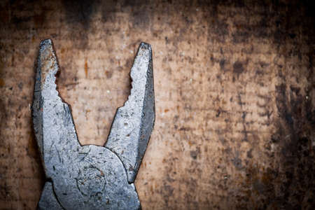 Color image of some pliers on a wooden plank.の写真素材