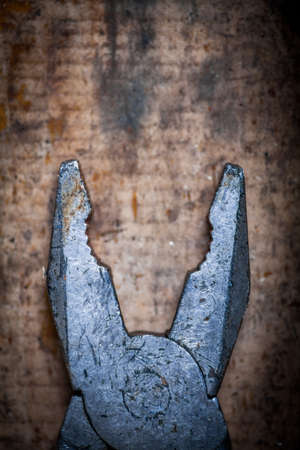 Color image of some pliers on a wooden plank.の写真素材