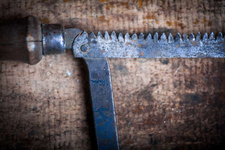 Color image of a hacksaw on a wooden plank.の写真素材