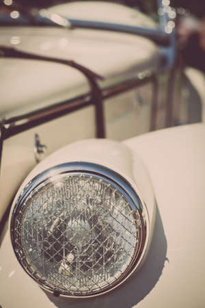 Color detail on the headlight of a vintage car.