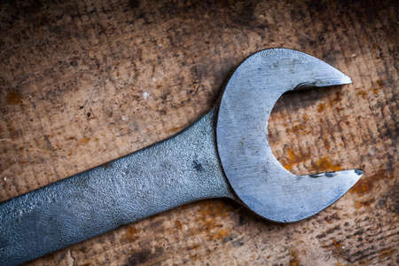 Color image of a wrench on a wooden plank.の写真素材