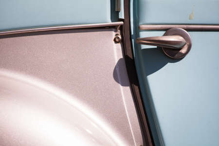 Color image of an old car door handle.