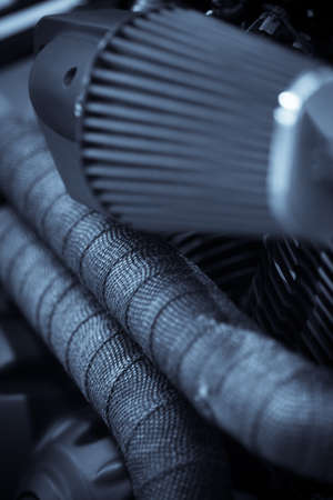 Detail of a motorcycle exhaust pipes and cylinders.