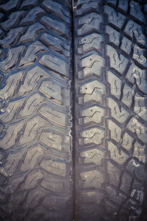 Color close up of some knobby car tires.
