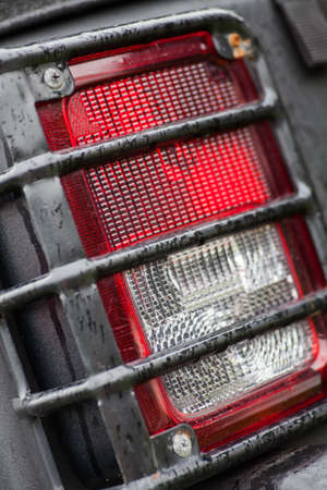 Detail on the rear light of a car on a rainy day.の写真素材