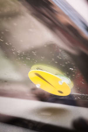 Color image of a beginner driver sign stuck on a car's windshield.の写真素材