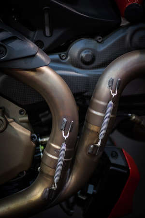 Detail of a motorcycle exhaust pipes and cylinders.