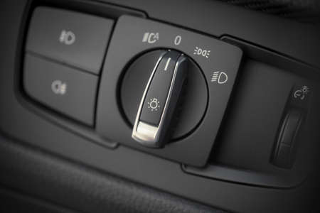 Detail of the headlight button in a car.