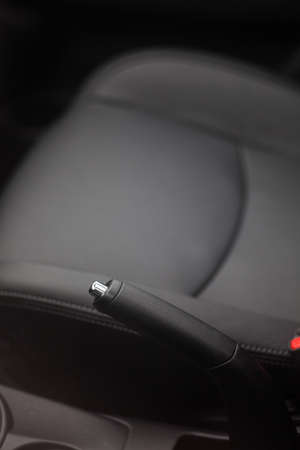 Close up shot of the hand brake of a car.