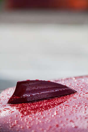 Close up picture of a car's antenna, on a rainy day.の写真素材