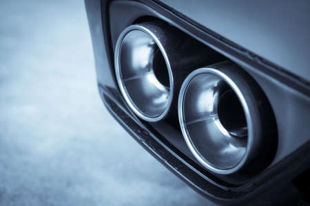 Close up shot of a car's double exhaust pipe.