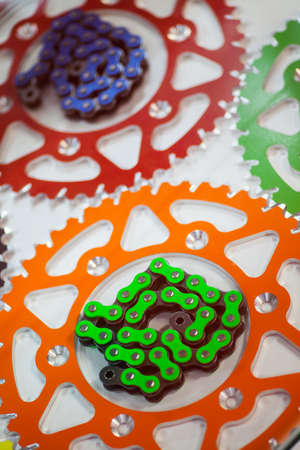 Color image of some motorcycle chains and sprockets.