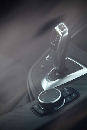 Close up shot of a gear stick inside a car.