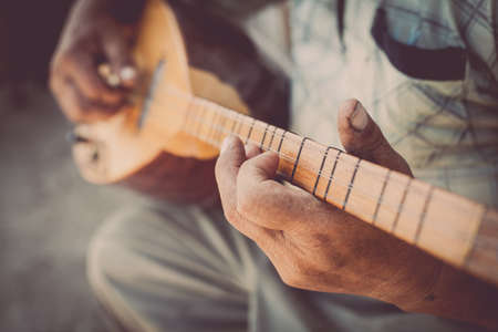 Close up shot of a man playing a Tatar instrument called "baglama".の写真素材