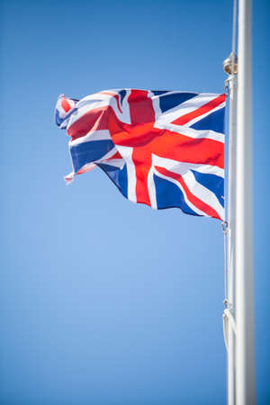 Color image of the United Kingdom flag, on cloudy background.の写真素材