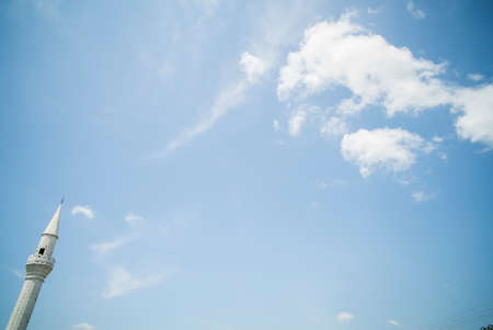 Color image of a minaret from a mosque, against a blue sky.の写真素材